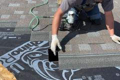 Worker-on-roof-replacing-shingles-1